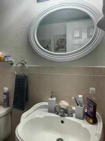 a bedroom with a bed and a mirror