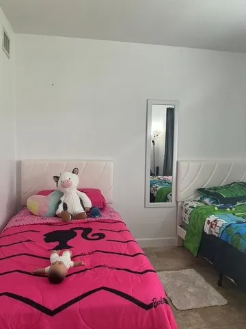 a view of kitchen with white cabinets