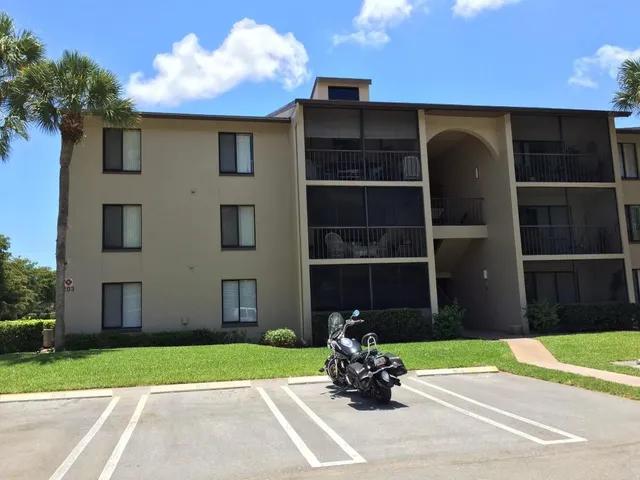 a view of a chair and table in the back yard