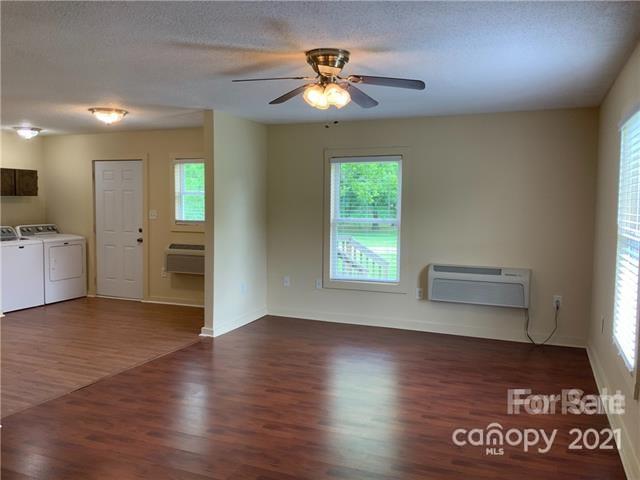 235 South Main Street Wingate, NC 28174 - Photo 4 of 9 wooden floor in an empty room with a window