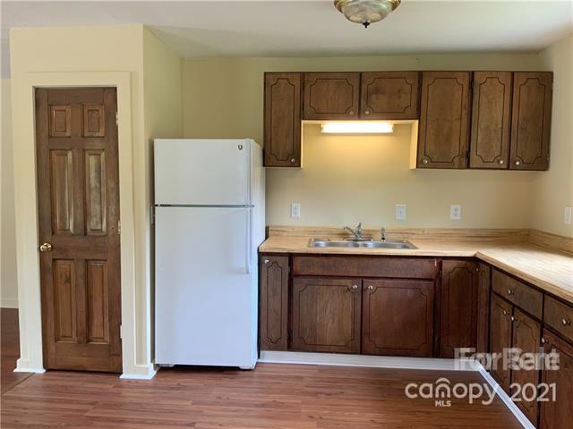 235 South Main Street Wingate, NC 28174 - Photo 5 of 9 a white refrigerator freezer sitting inside of a kitchen