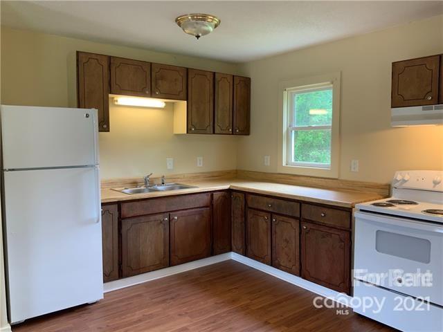 235 South Main Street Wingate, NC 28174 - Photo 7 of 9 a kitchen with granite countertop a sink cabinets stainless steel appliances and a window