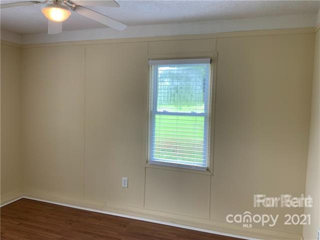 235 South Main Street Wingate, NC 28174 - Photo 9 of 9 a view of an empty room with wooden floor and a window