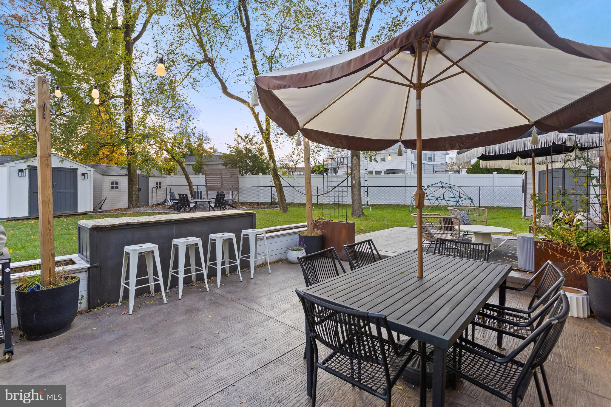 2 Spruce Road Burlington, NJ 08016 - Photo 26 of 34 a view of a table and chairs under an umbrella
