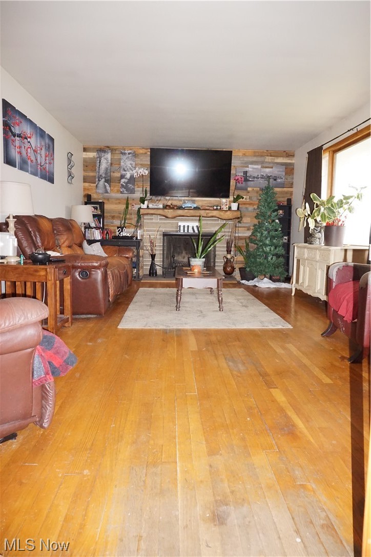 4611 8th Street Northwest Canton, OH 44708 - Photo 4 of 29 Living room featuring light wood-type flooring and a stone fireplace