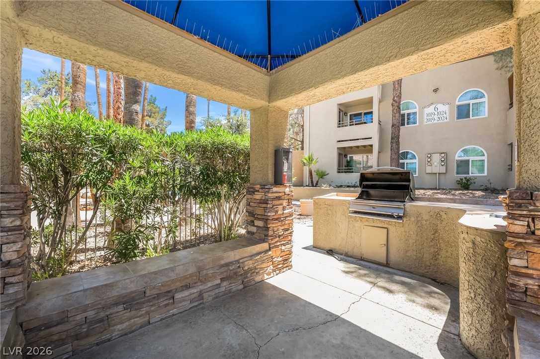 3145 East Flamingo Road, Unit 1092 Las Vegas, NV 89121 - Photo 29 of 33 Enjoy outdoor entertaining with a built-in barbecue and shaded patio area.