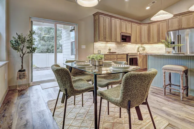 a dining room with furniture and a kitchen view