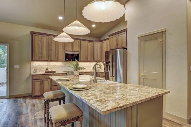 a kitchen with cabinets and stainless steel appliances