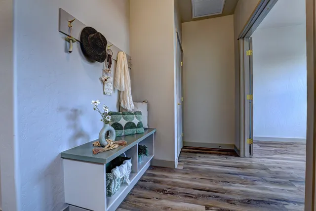 a hallway with a white stove top oven and wooden floor