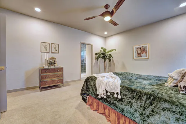 a bedroom with bed and a chandelier