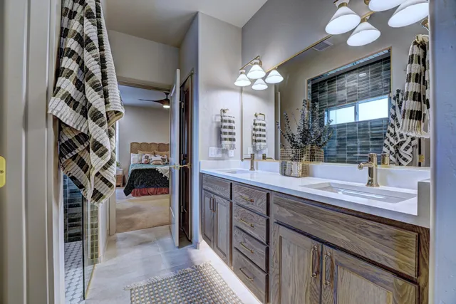 a spacious bathroom with a sink a mirror and a shower