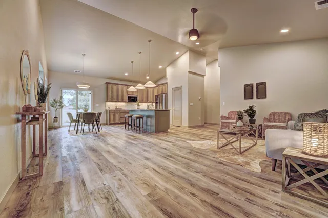 a view of a room with kitchen view and a wooden floor
