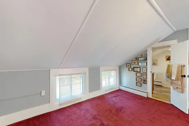 a bathroom with a toilet and a shower curtain