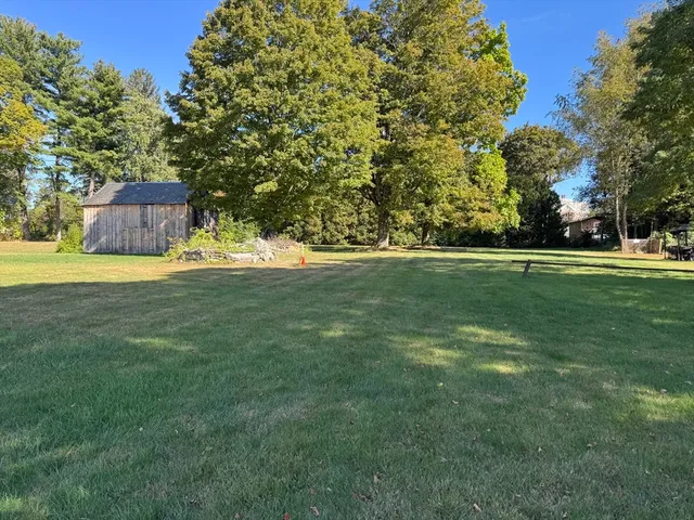 an aerial view of a house with a yard and garden
