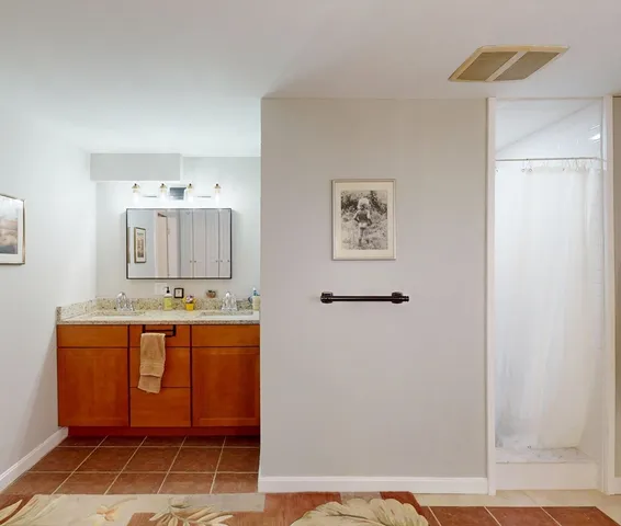 a bathroom with a toilet a sink and shower