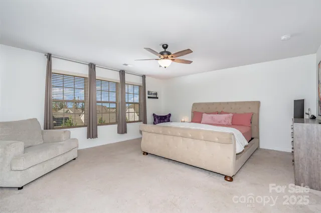 a spacious bedroom with a bed and a large window