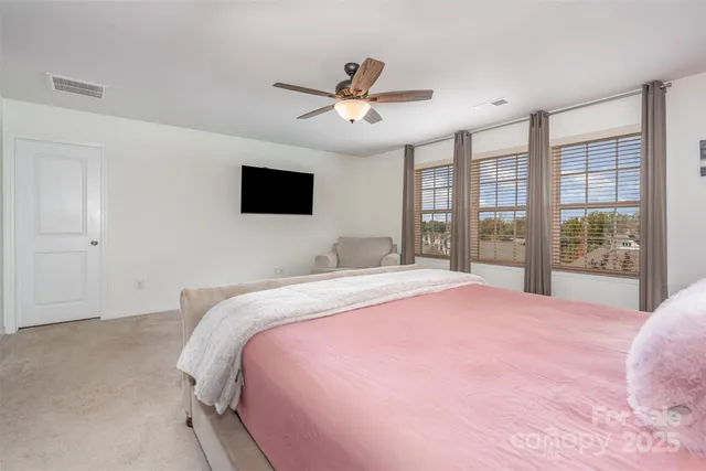 a bedroom with a large bed and a large window