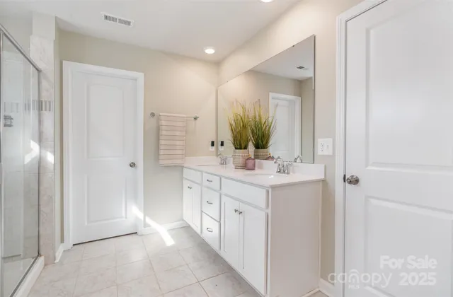 a bathroom with a double vanity sink and a mirror