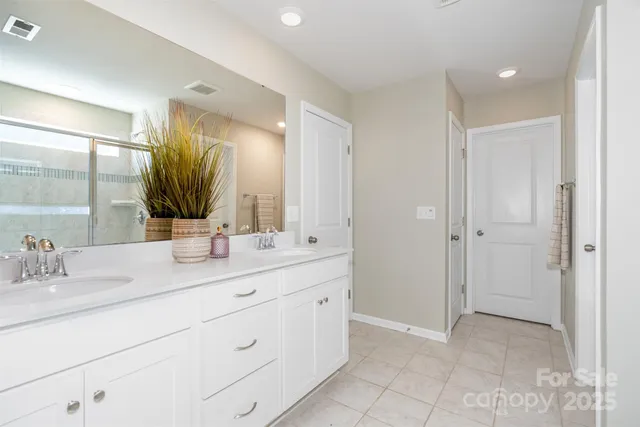 a bathroom with a double vanity sink mirror and next
