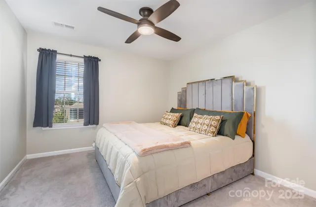 a bedroom with a bed and a large window