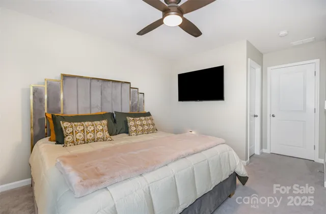 a bedroom with a bed and a flat screen tv