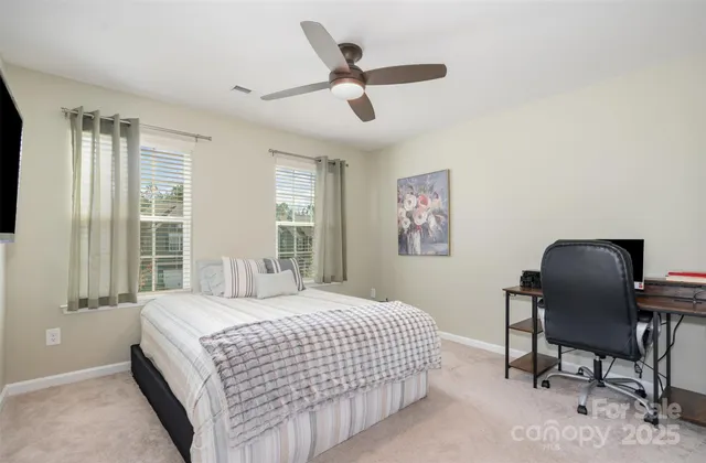 a bedroom with a bed and a desk