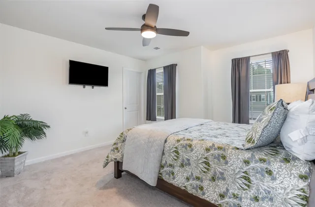 a bedroom with a bed and a potted plant
