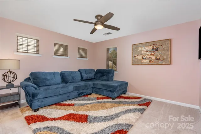 a living room with furniture and white walls