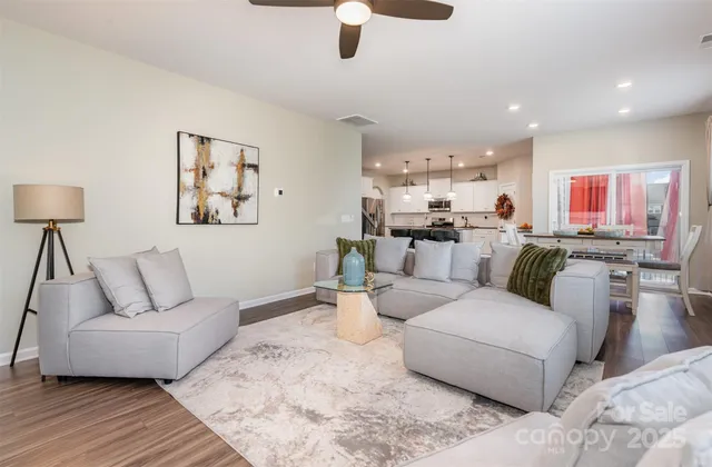a living room with furniture and a lamp