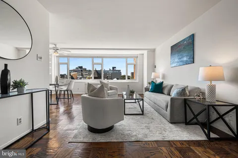 a living room with lots of furniture and a rug