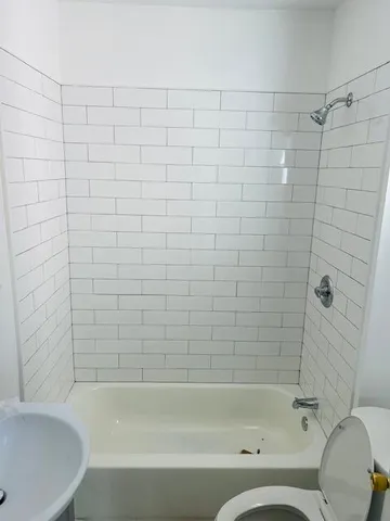 a bathroom with a bathtub and shower