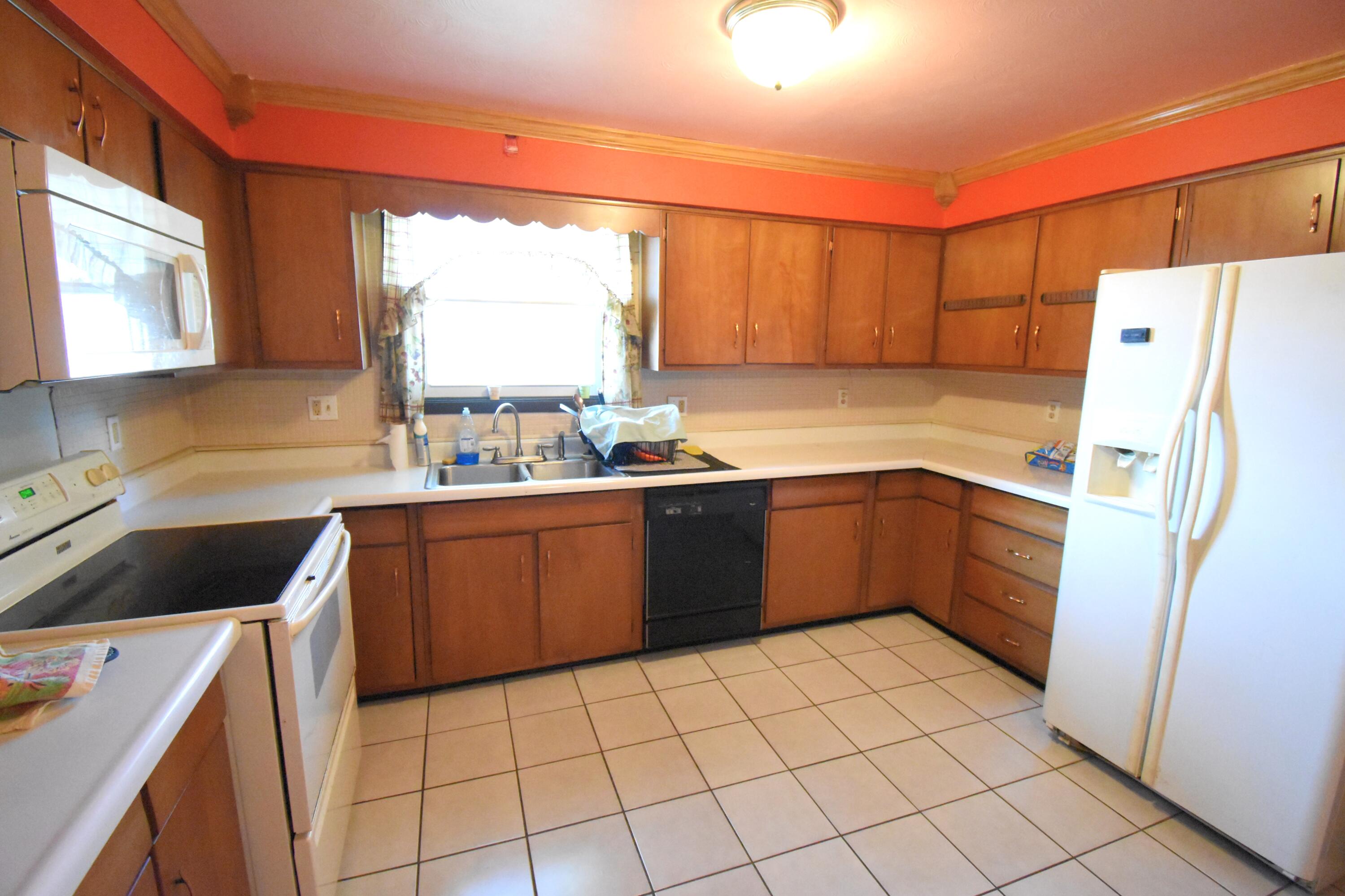 719 North Monroe Street Rensselaer, IN 47978 - Photo 14 of 41 a kitchen with a sink a stove a refrigerator and cabinets