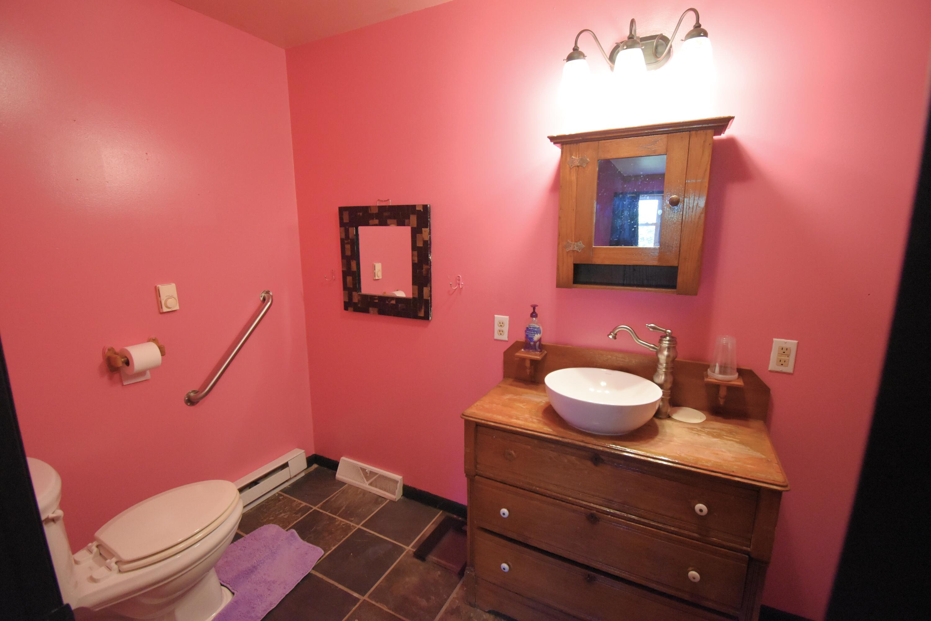 719 North Monroe Street Rensselaer, IN 47978 - Photo 25 of 41 a bathroom with a sink vanity mirror and toilet