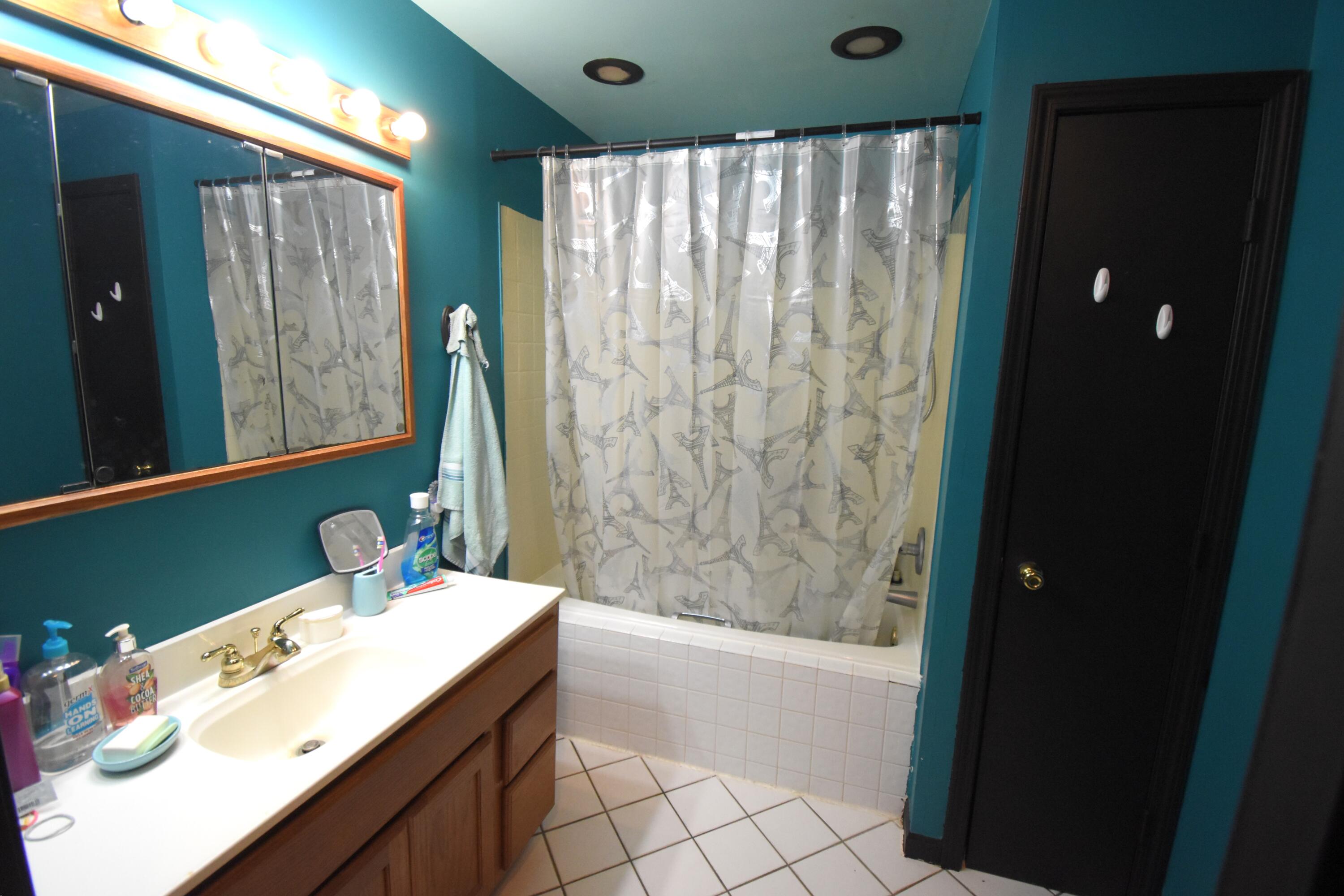 719 North Monroe Street Rensselaer, IN 47978 - Photo 29 of 41 a bathroom with a double vanity sink and a mirror
