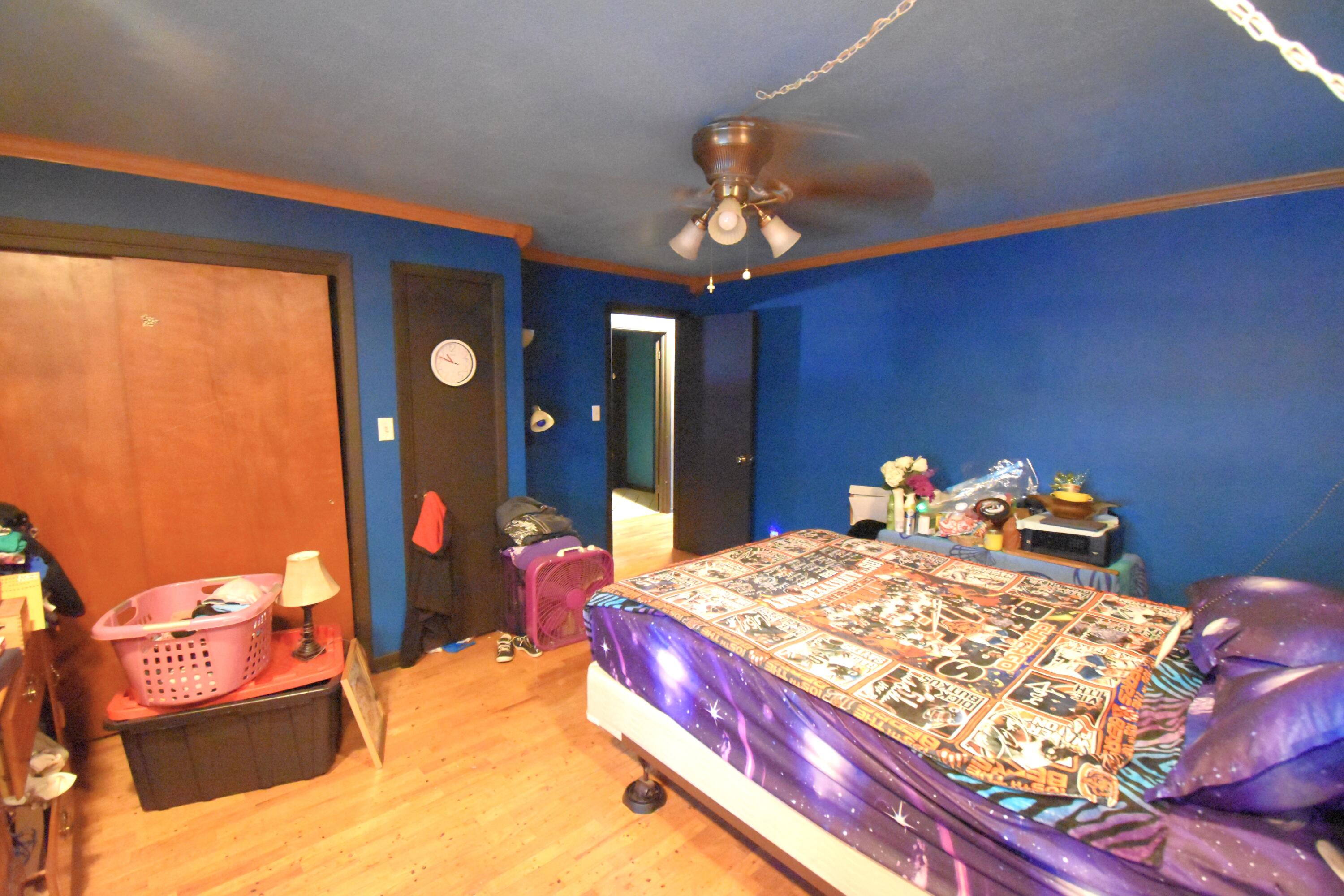 719 North Monroe Street Rensselaer, IN 47978 - Photo 31 of 41 a bed room with a bed and a chandelier