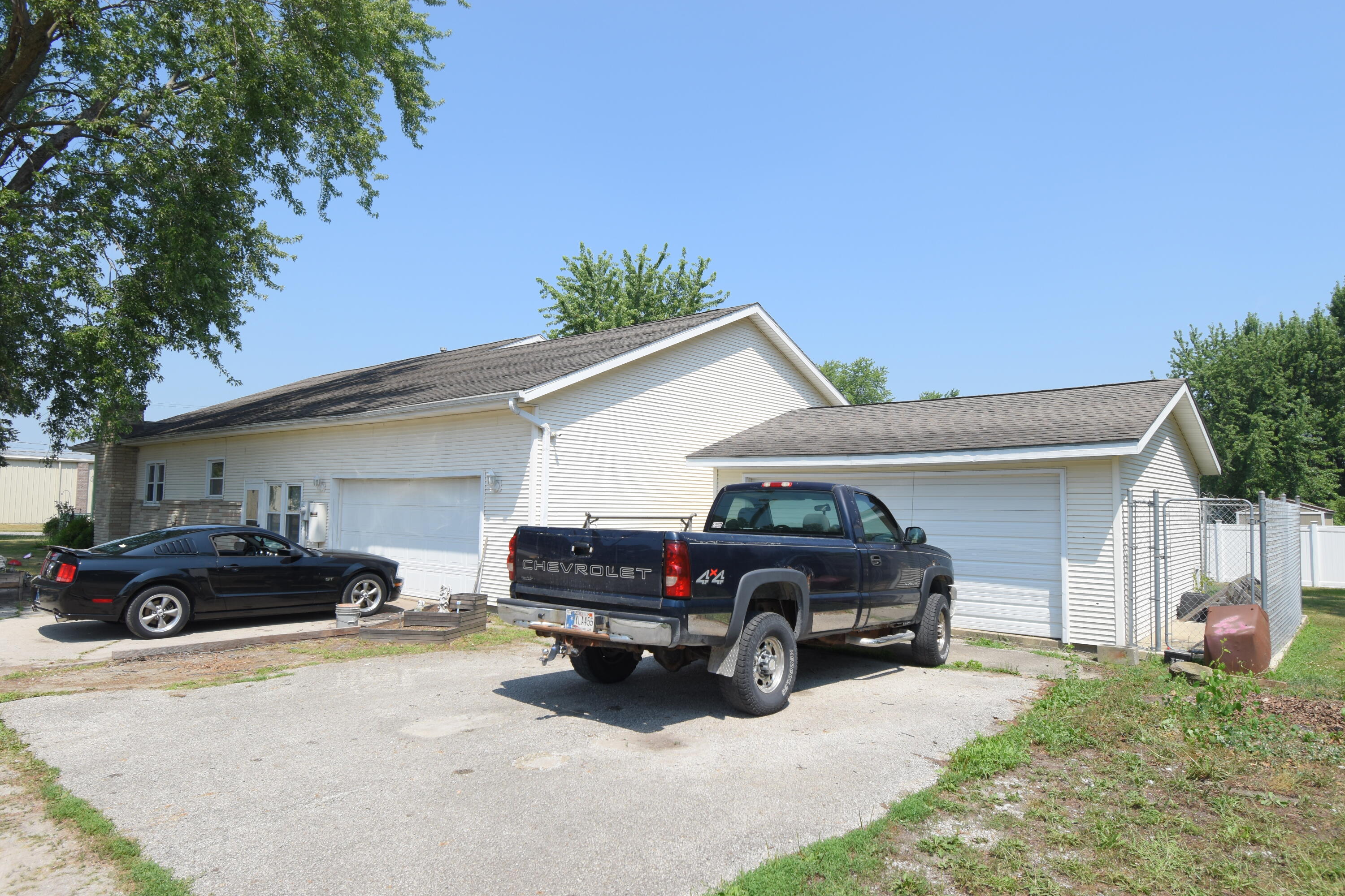 719 North Monroe Street Rensselaer, IN 47978 - Photo 9 of 41 a car parked in front of white house