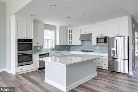 a kitchen with a refrigerator stove and microwave