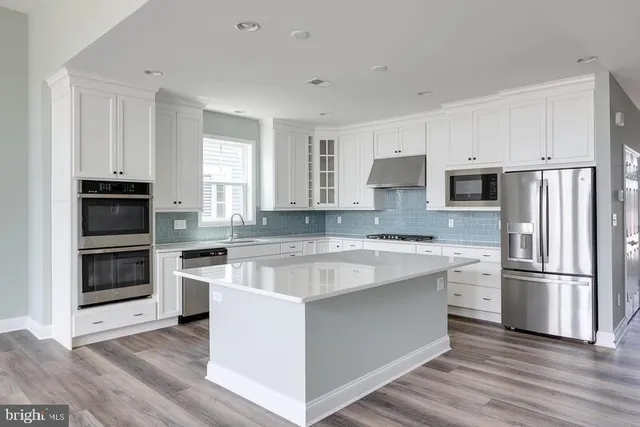 a kitchen with a refrigerator stove and microwave