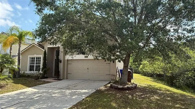 a view of a garage with a tree