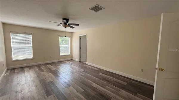 a bathroom with a tub shower vanity and a sink