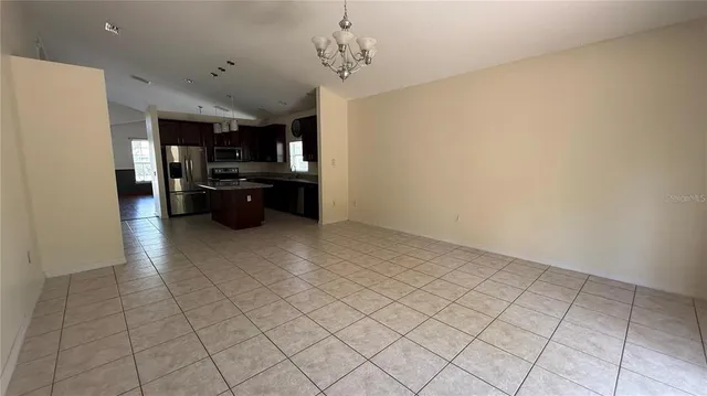 a kitchen with granite countertop a refrigerator and a stove