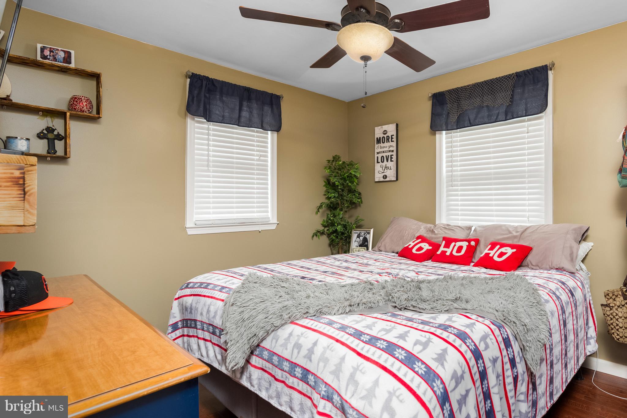 8217 Northview Road Baltimore, MD 21222 - Photo 14 of 21 a bedroom with a bed and a chandelier