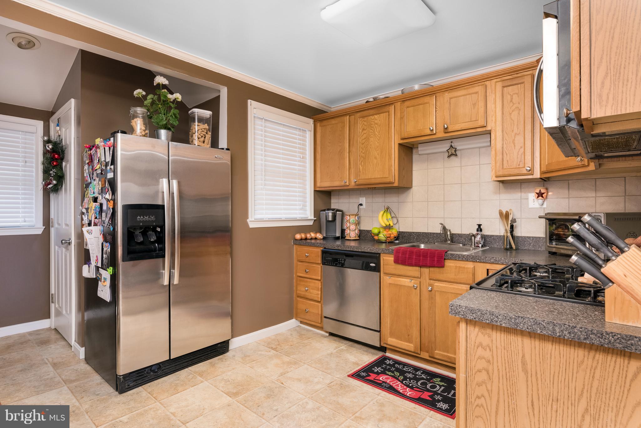 8217 Northview Road Baltimore, MD 21222 - Photo 7 of 21 a kitchen with stainless steel appliances granite countertop a refrigerator stove and sink