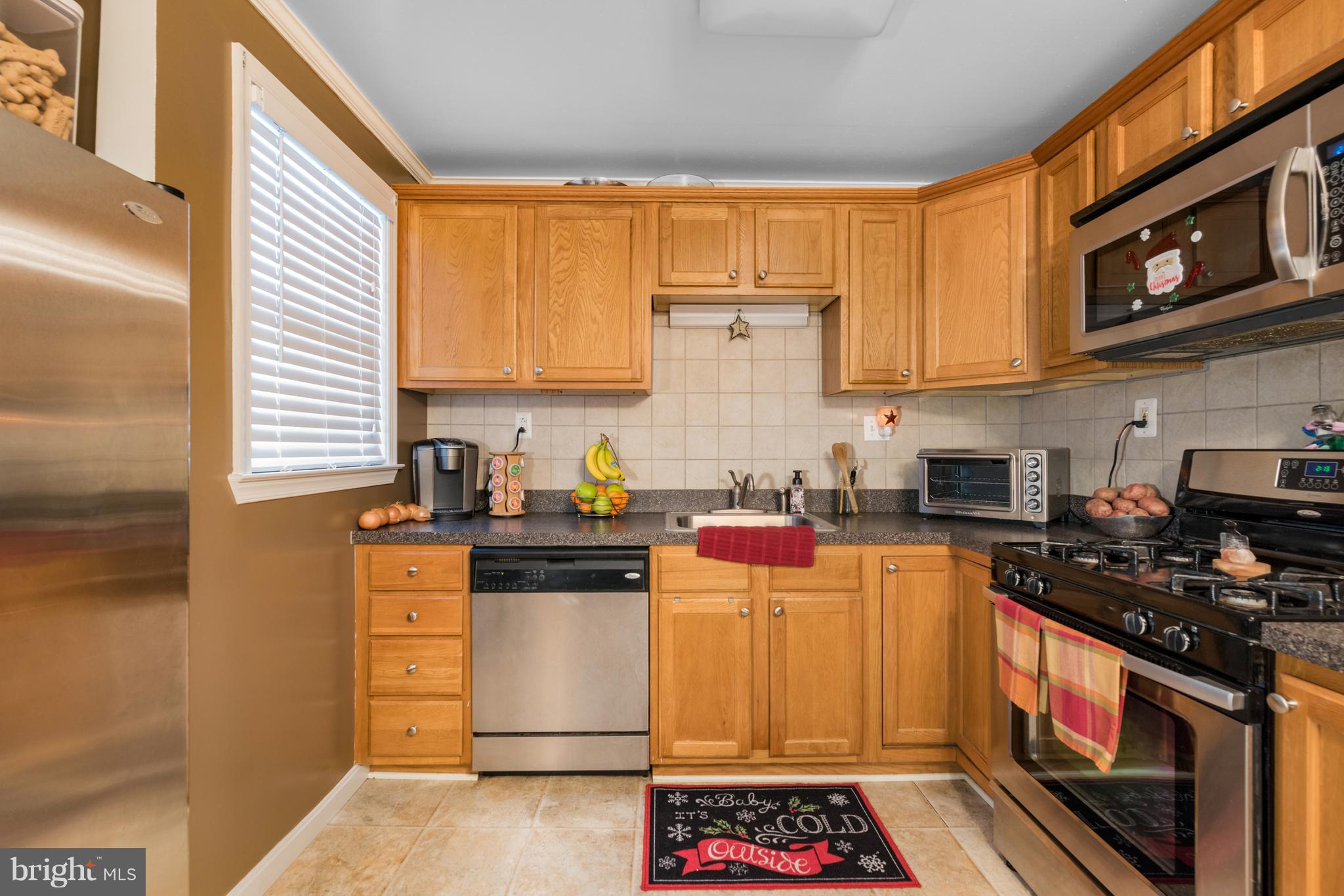8217 Northview Road Baltimore, MD 21222 - Photo 8 of 21 a kitchen with stainless steel appliances a stove a sink and a microwave
