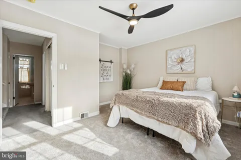 a bedroom with a bed and a painting on the wall