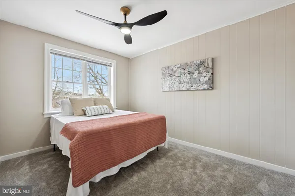 a bedroom with a large bed and a window