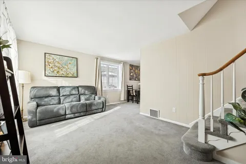a view of a livingroom with furniture and a window