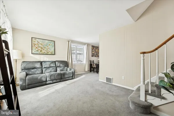 a view of a livingroom with furniture and a window