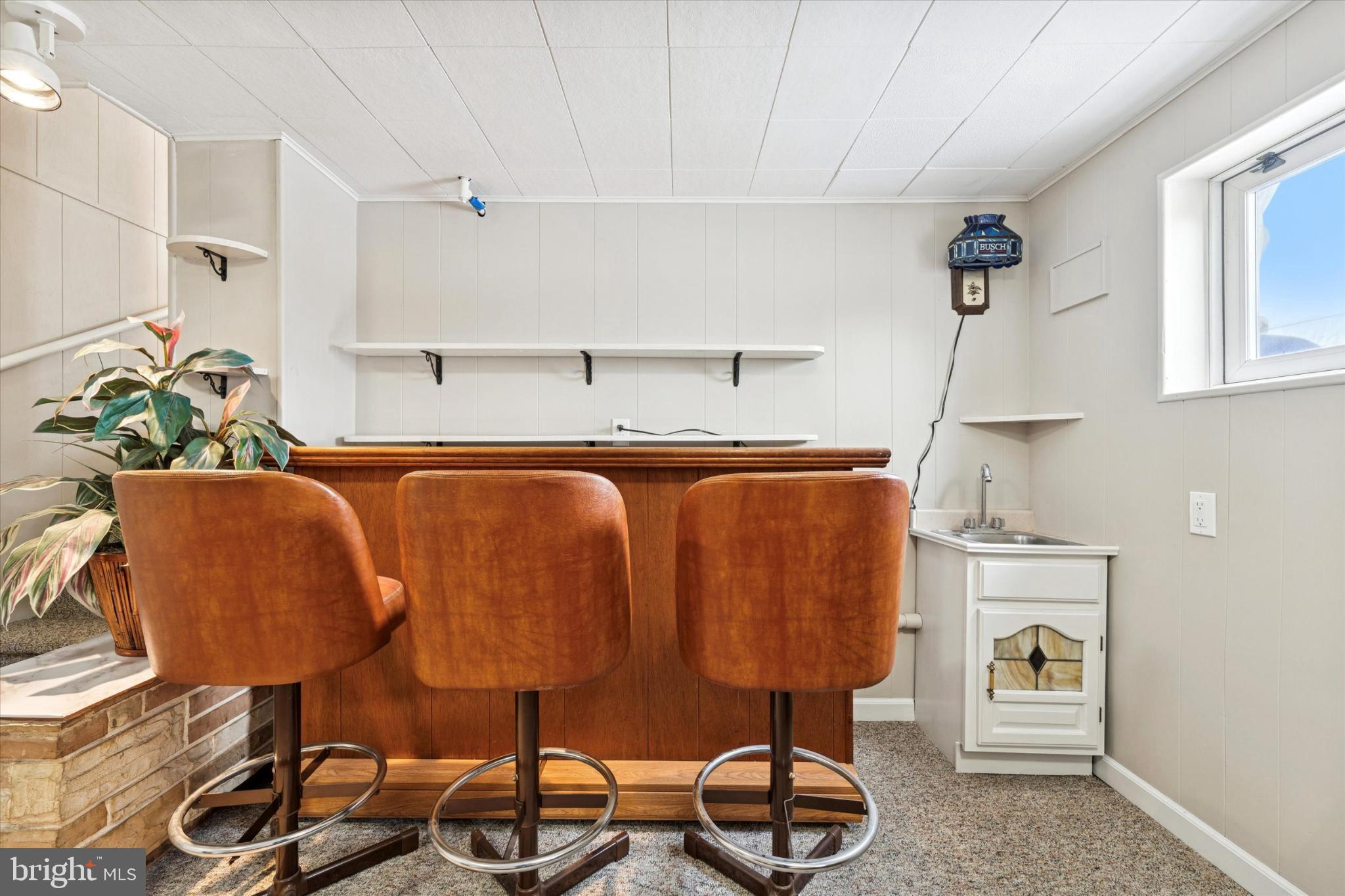 8711 Old Line Road Philadelphia, PA 19128 - Photo 21 of 25 Charming basement bar with cozy seating.