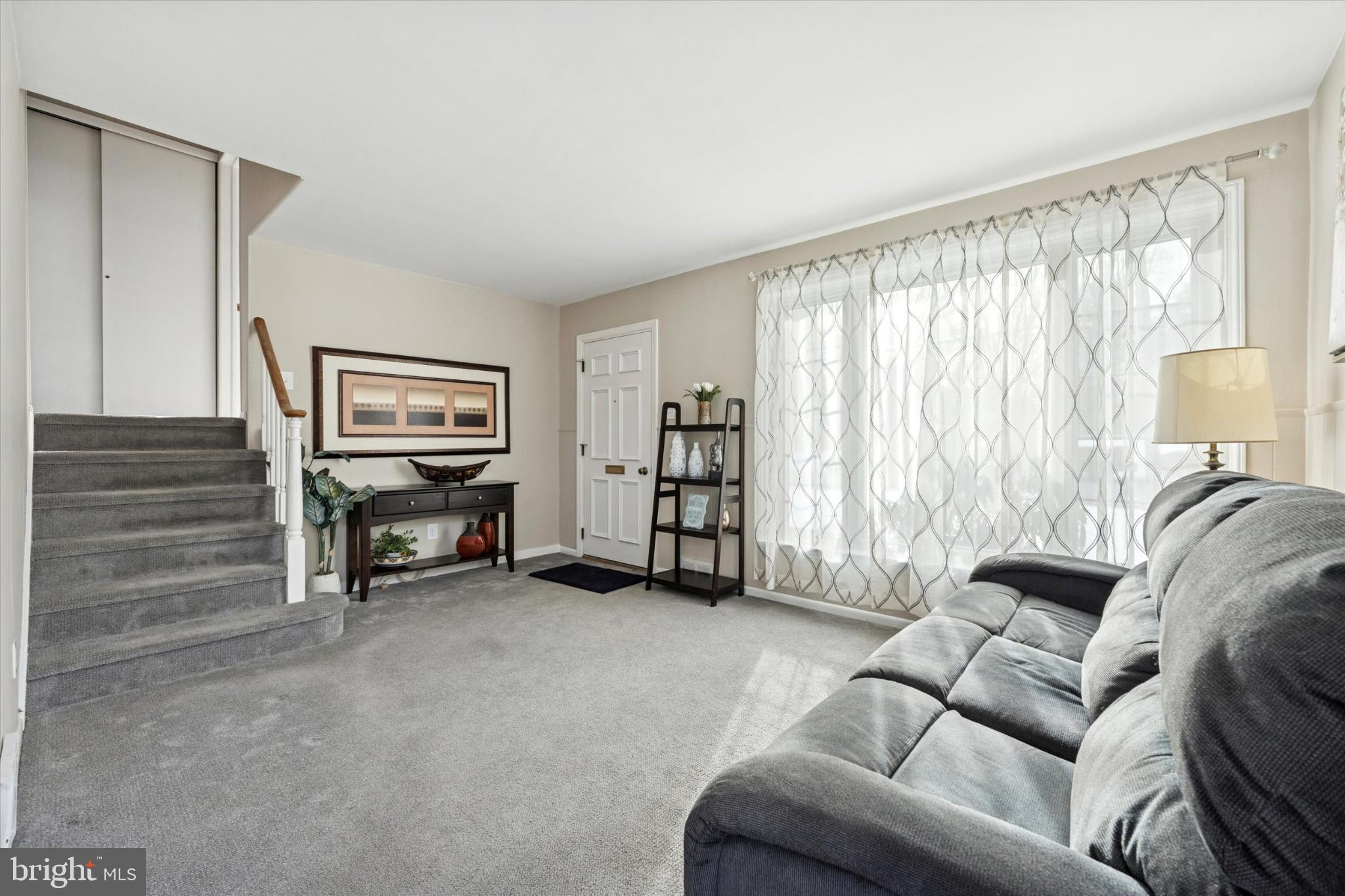 8711 Old Line Road Philadelphia, PA 19128 - Photo 4 of 21 a living room with furniture a ceiling fan and a window